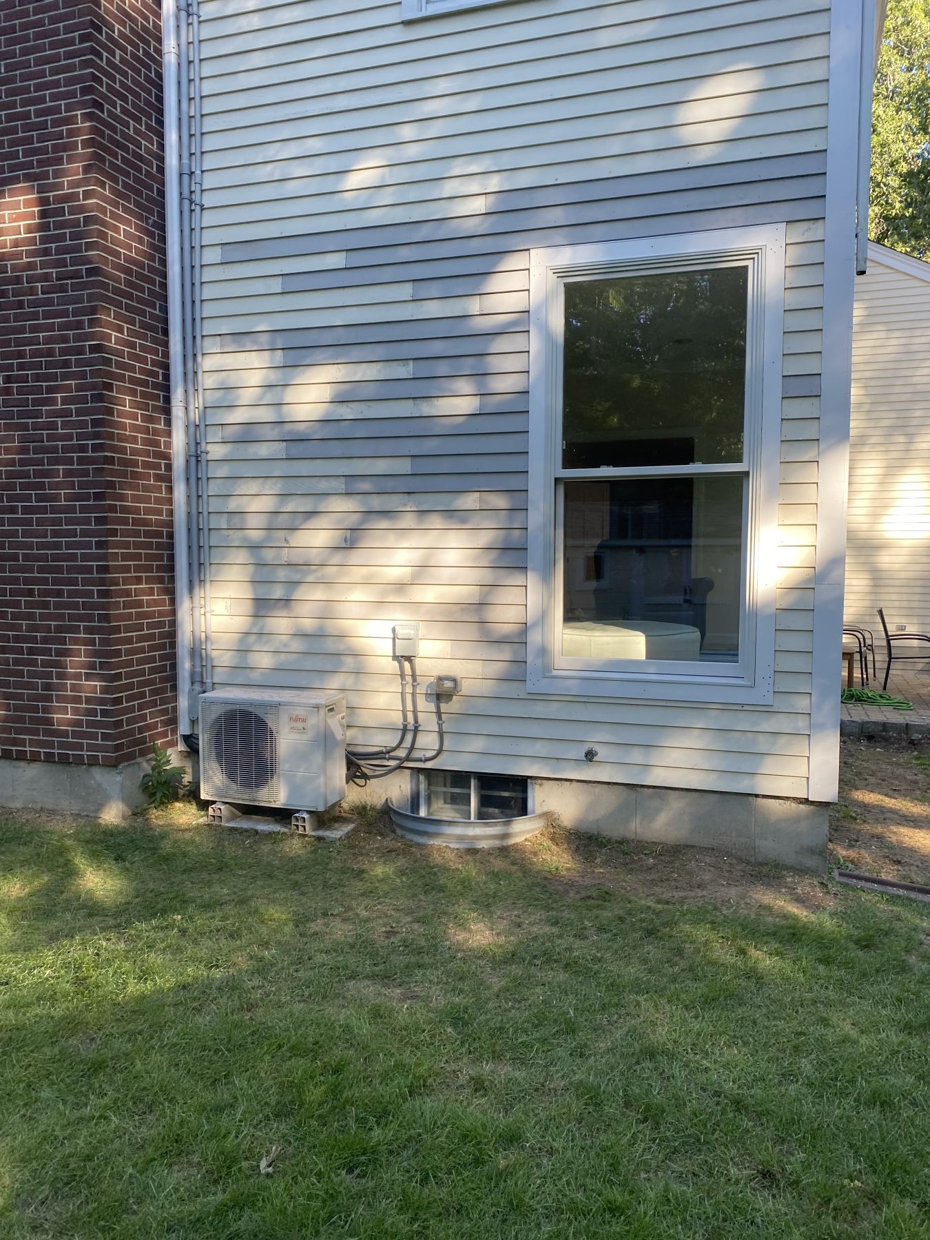 Double-hung replacement window in a clapboard wall